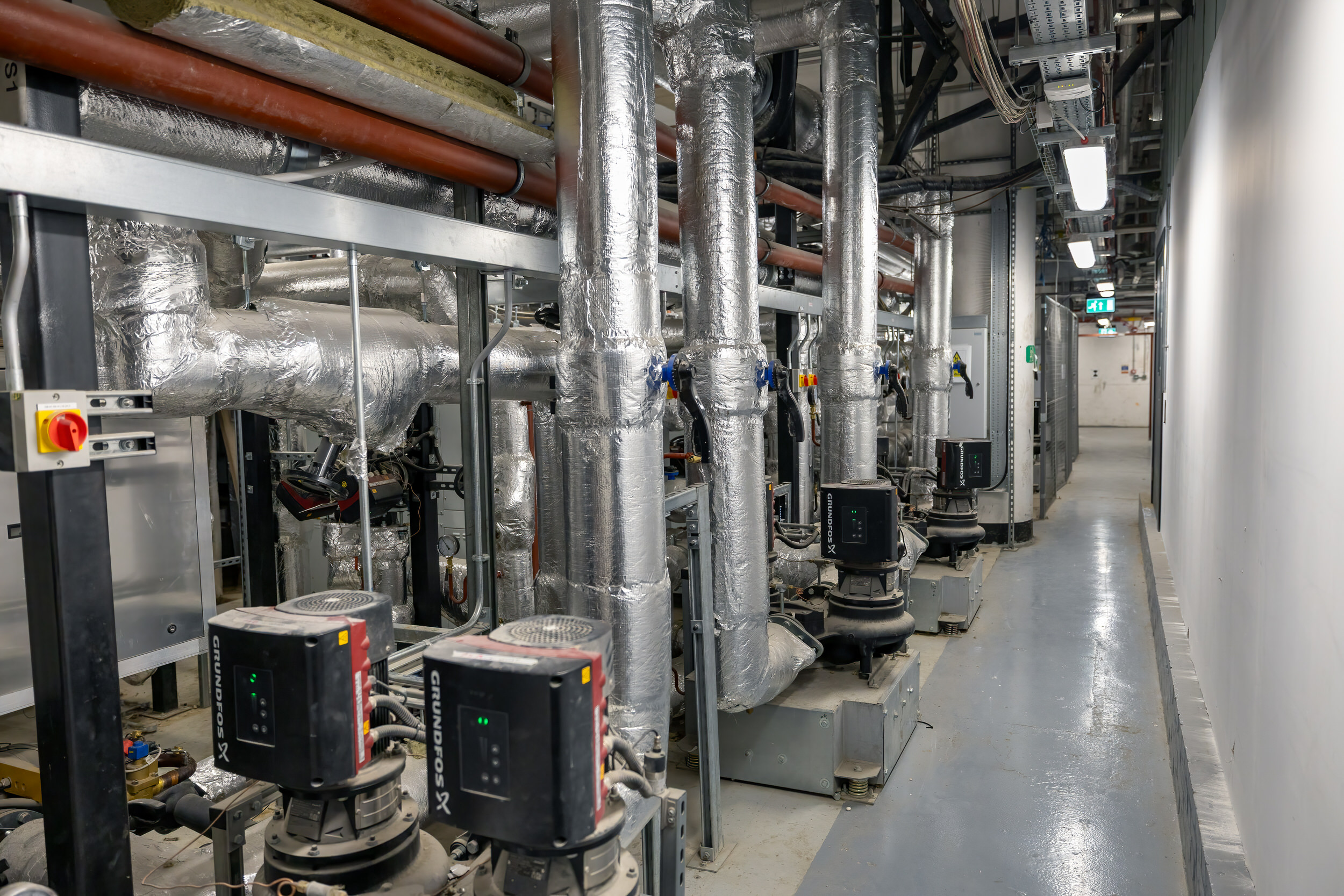 Plantroom pumps and pipework forming part of a commercial mechanical installation