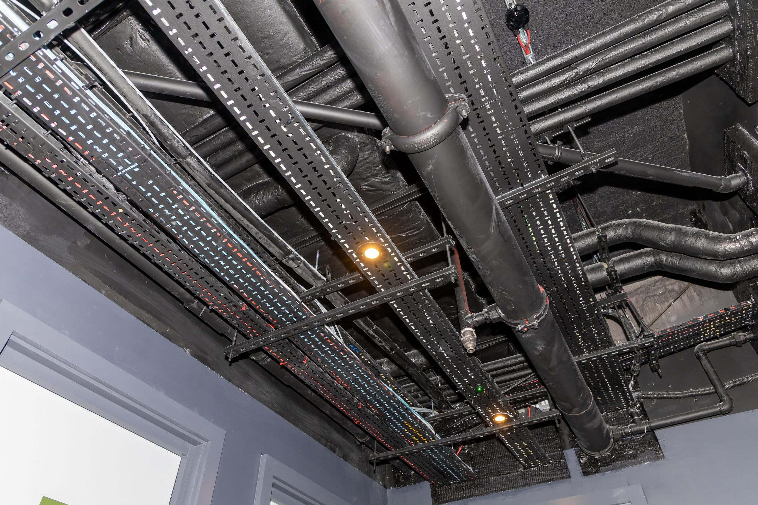 Mechanical and electrical services installed at high level — ductwork, containment and pipework