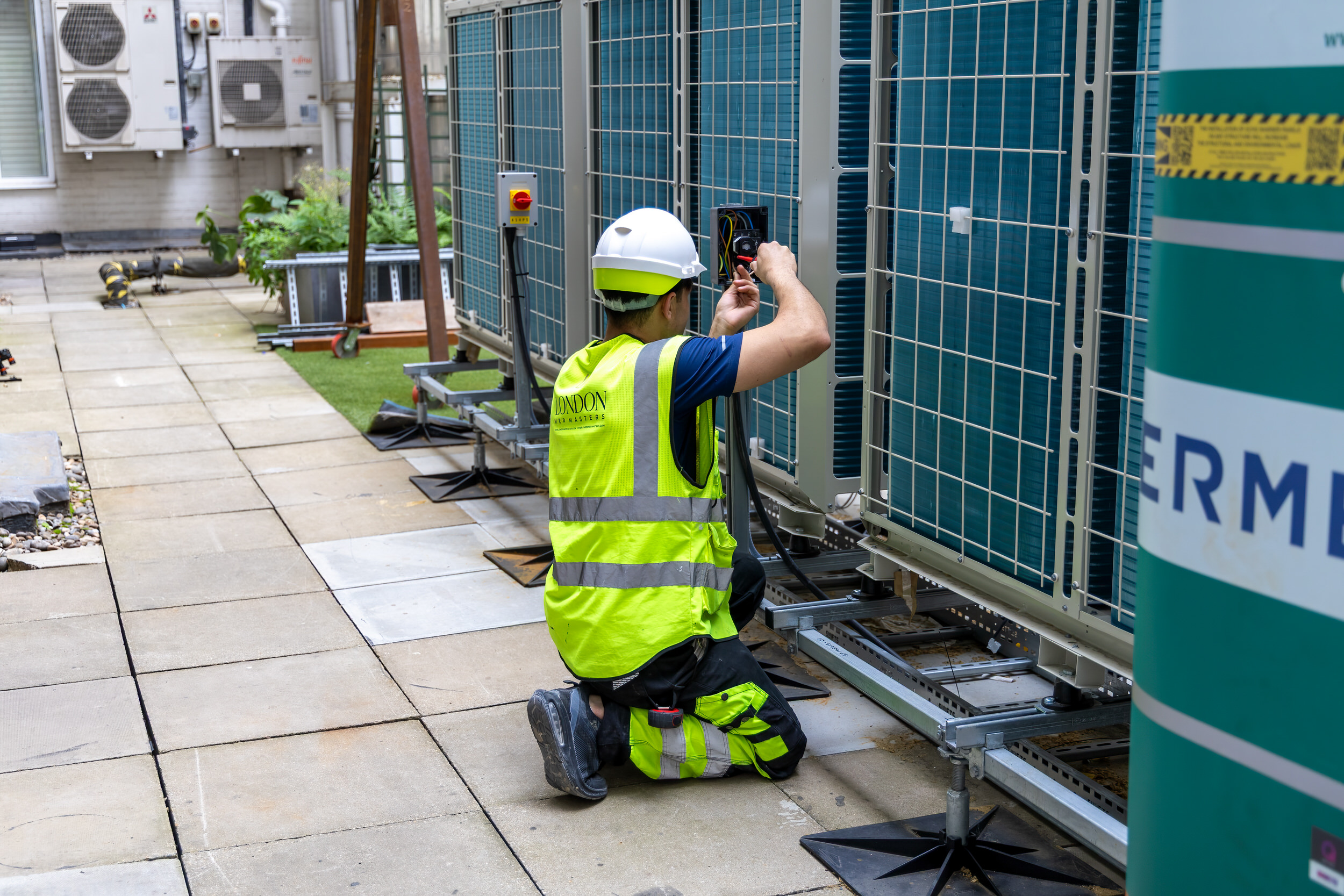 Engineer commissioning externally mounted condenser units