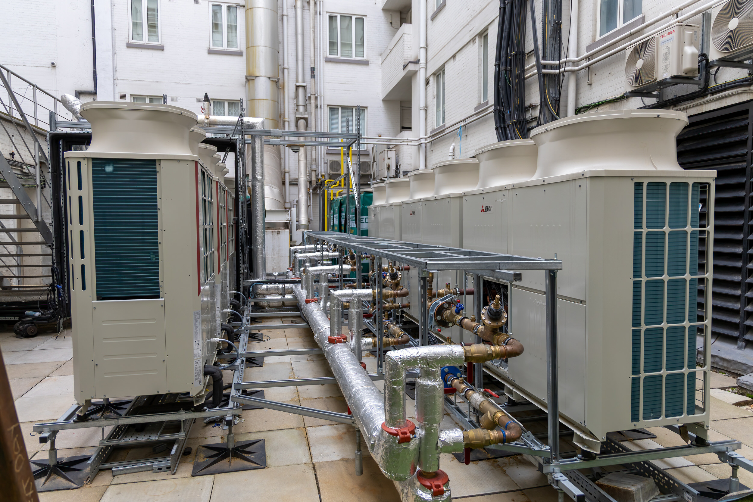 Park Lane — external condenser plant and pipework serving the penthouses